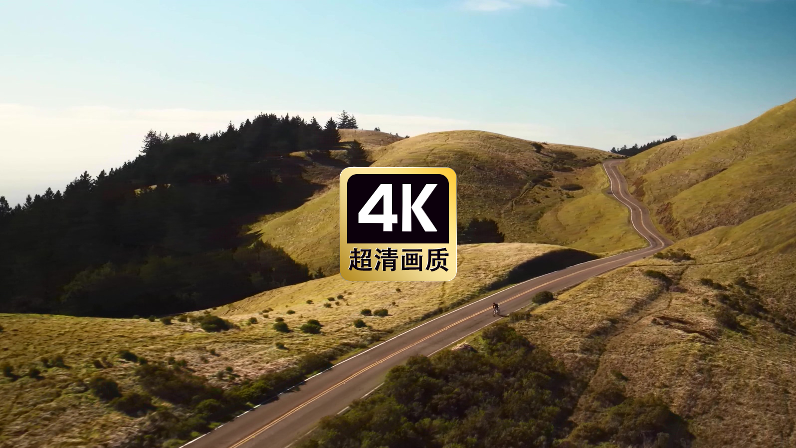 航拍山间道路上骑自行车的人