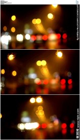 开车行驶在夜晚霓虹灯光斑街道上