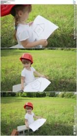 小女孩草地拿着画纸