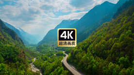 航拍素材山谷里公路上飞驰的汽车