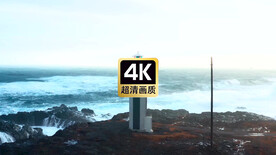 航拍海浪拍打礁石海边灯塔